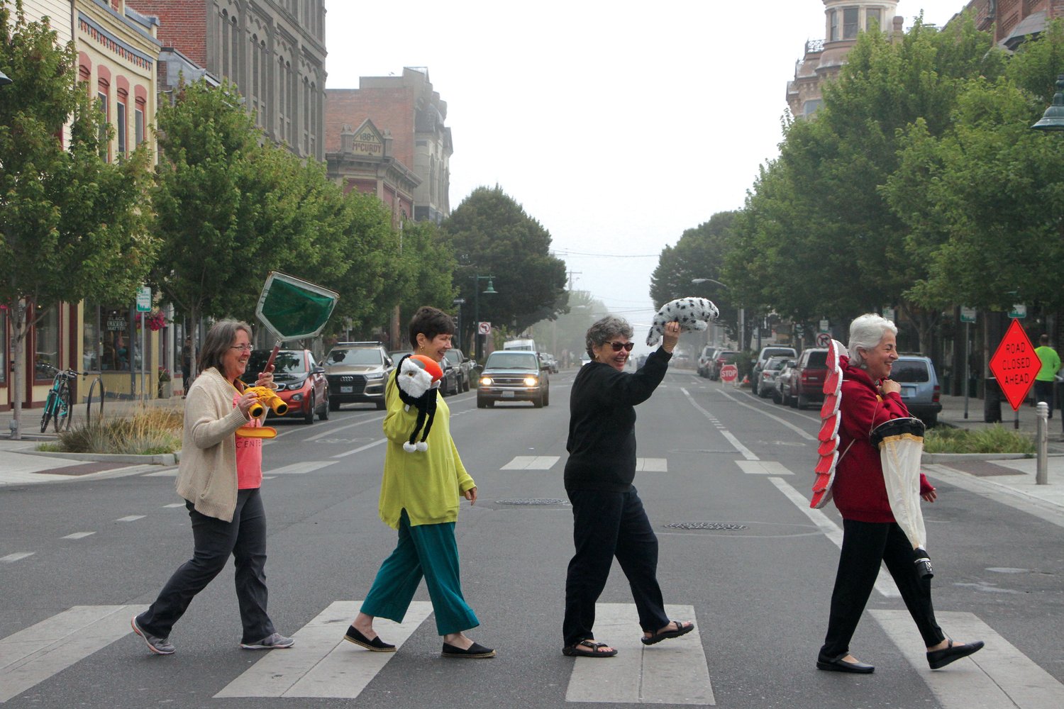 The science center’s board and staff members make their way across the historic downtown street a la Abbey Road with iconic artifacts in tow.